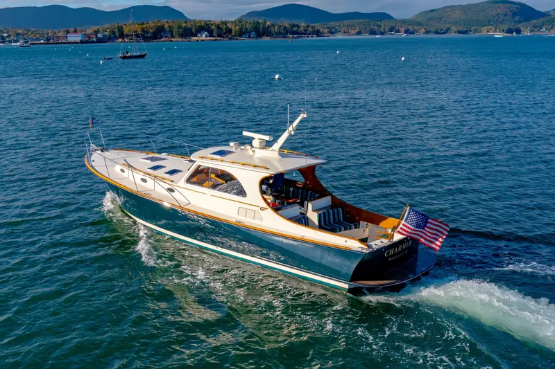 Slide: The Image of 1999 Hinckley Talaria 44 Express yacht cruising on scenic blue waters. - 12