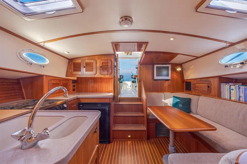 Slide: The Image of Luxurious 1999 Hinckley Talaria 44 Express yacht interior with wood finish and cozy seating. - 27