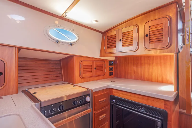 Slide: The Image of Interior of 1999 Hinckley Talaria 44 Express yacht with wooden cabinetry and modern appliances. - 33