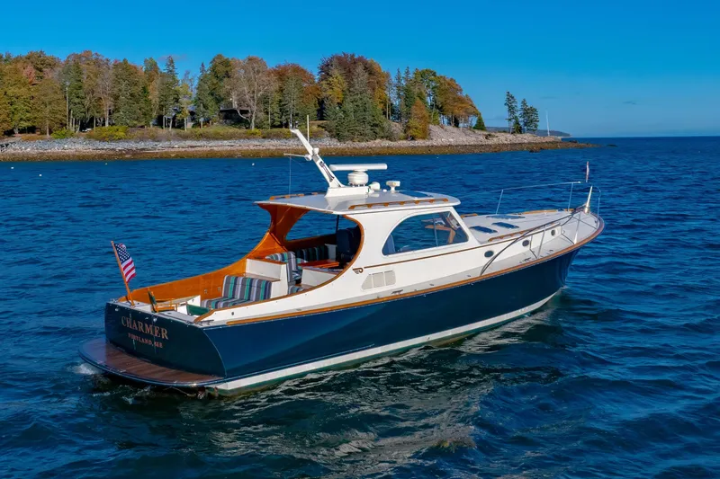 Slide: The Image of 1999 Hinckley Talaria 44 Express yacht cruising on a scenic blue ocean. - 5