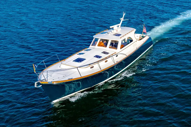 Slide: The Image of 1999 Hinckley Talaria 44 Express yacht cruising on open blue water. - 8