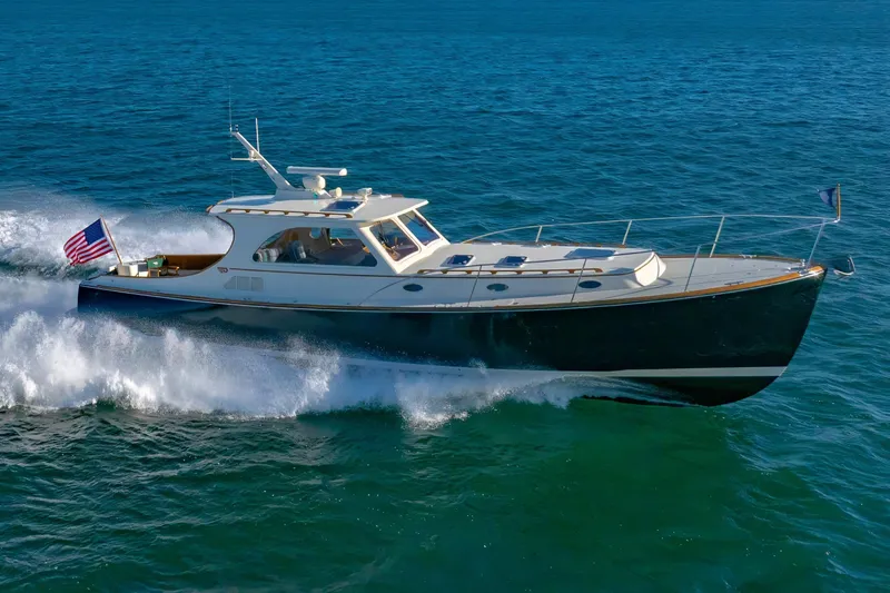 Slide: The Image of 1999 Hinckley Talaria 44 Express yacht cruising on open water. - 1