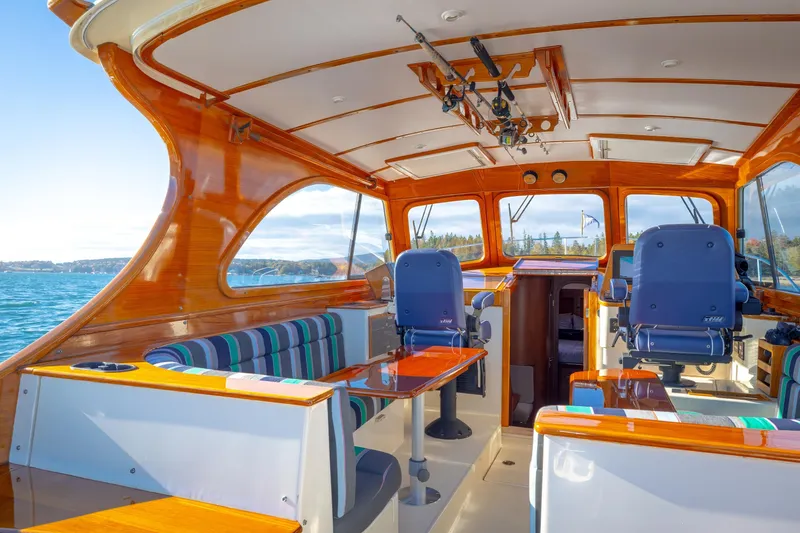 Slide: The Image of Interior of a 1999 Hinckley Talaria 44 Express yacht with polished wood and seating. - 17