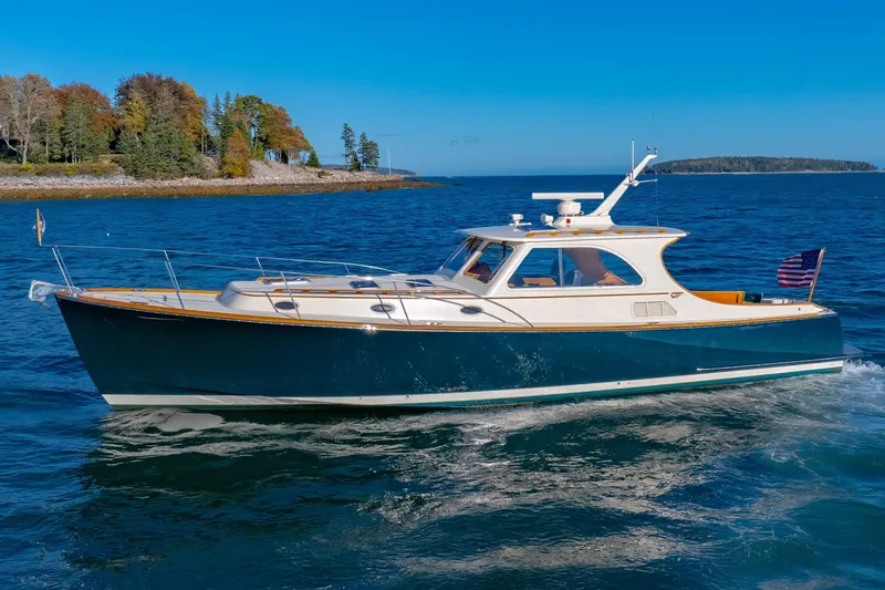 Slide: The Image of 1999 Hinckley Talaria 44 Express yacht cruising on a clear blue sea. - 2