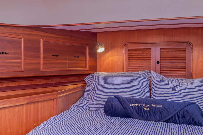 Slide: The Image of Interior cabin of 1999 Hinckley Talaria 44 Express yacht with striped bedding. - 39