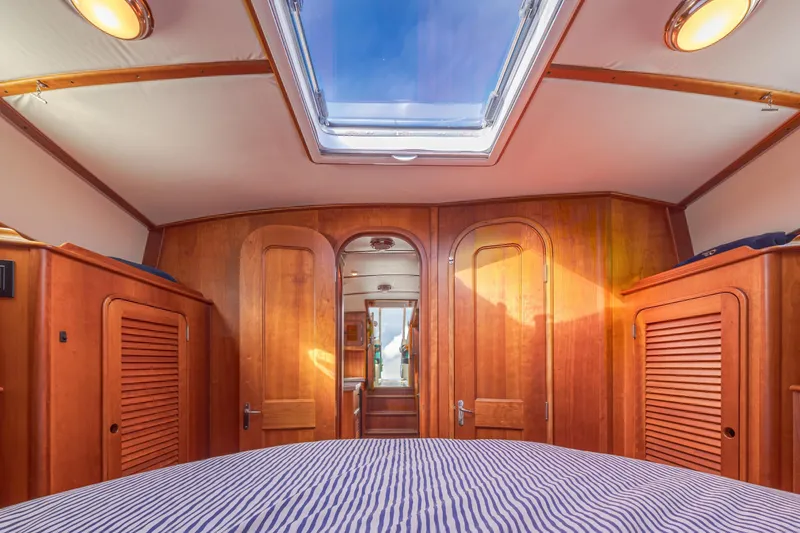 Slide: The Image of Interior of 1999 Hinckley Talaria 44 Express yacht with wooden cabinetry and skylight. - 40