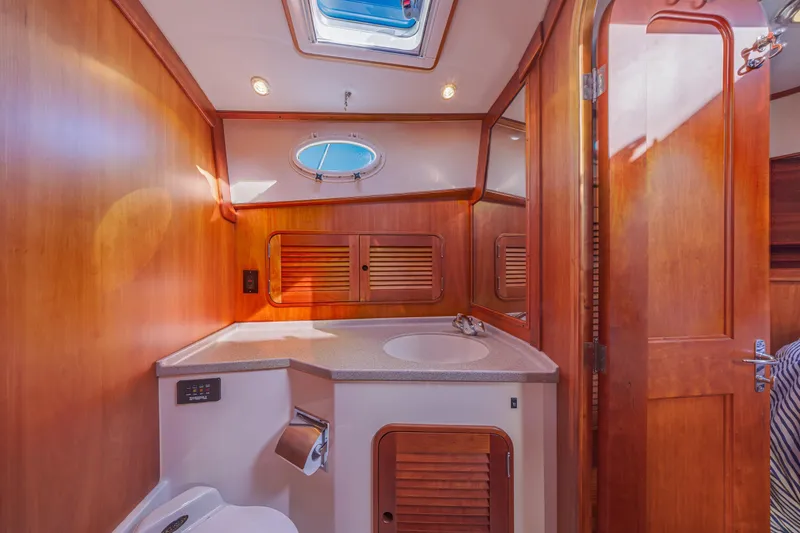 Slide: The Image of Luxurious 1999 Hinckley Talaria 44 Express yacht bathroom with wood accents and skylight. - 43