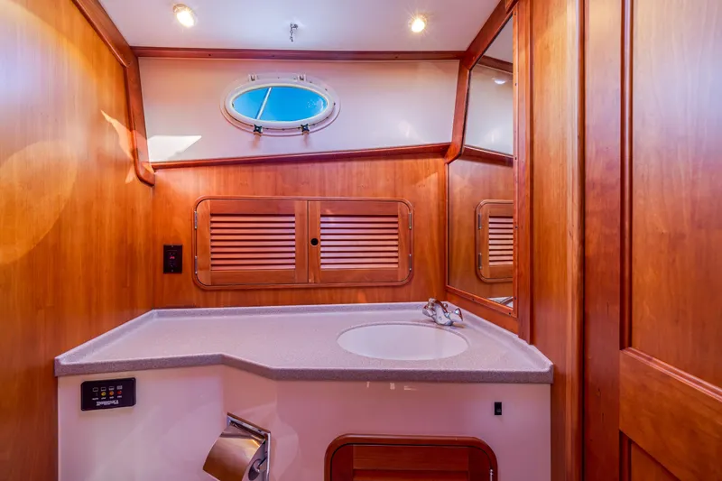 Slide: The Image of Luxurious wooden bathroom interior of 1999 Hinckley Talaria 44 Express yacht. - 44
