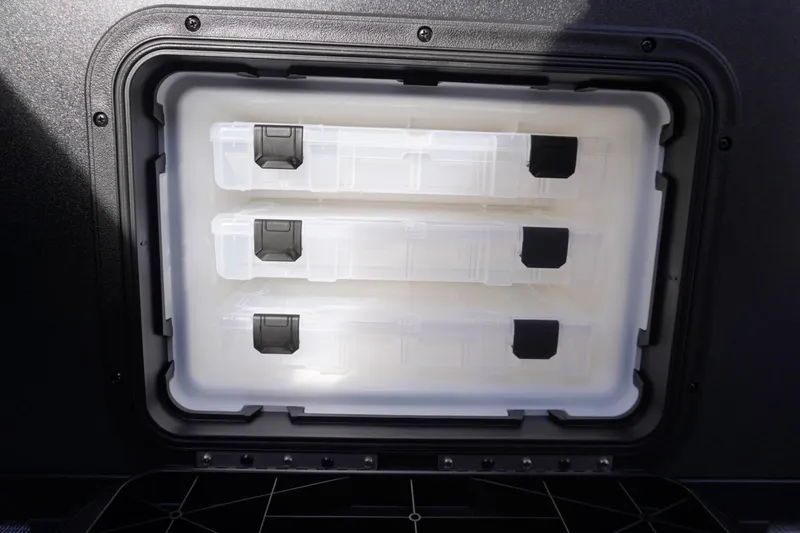 Slide: The Image of Storage compartment with three transparent containers in a 2026 Viaggio Lago V-R vehicle. - 24