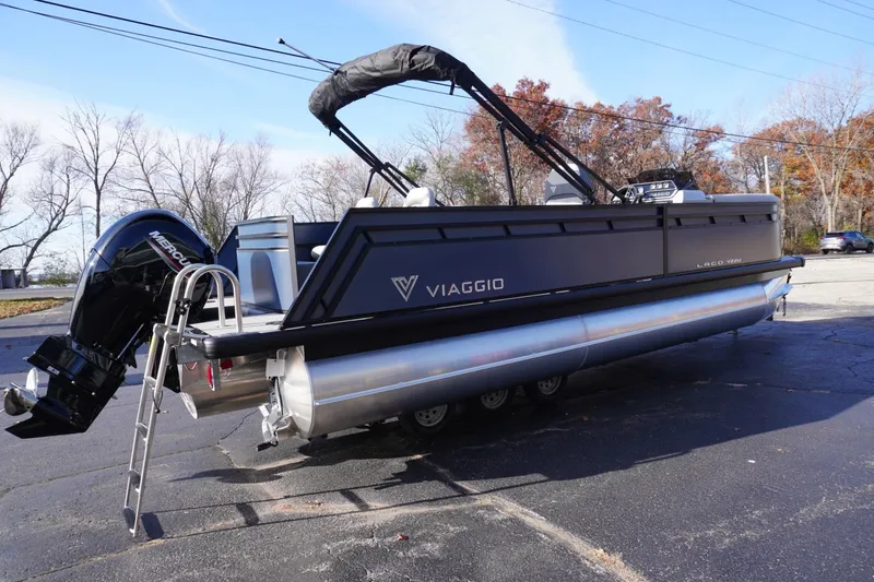 Slide: The Image of 2026 Viaggio Lago V-R pontoon boat with Mercury outboard motor, parked on pavement. - 5