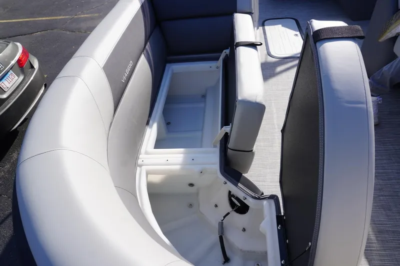 Slide: The Image of 2026 Viaggio Lago V-R boat interior with open storage compartment and cushioned seating. - 58