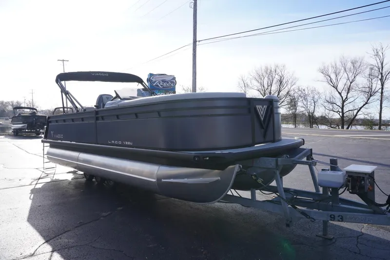 Slide: The Image of 2026 Viaggio Lago V-R pontoon boat on trailer, parked outdoors. - 6