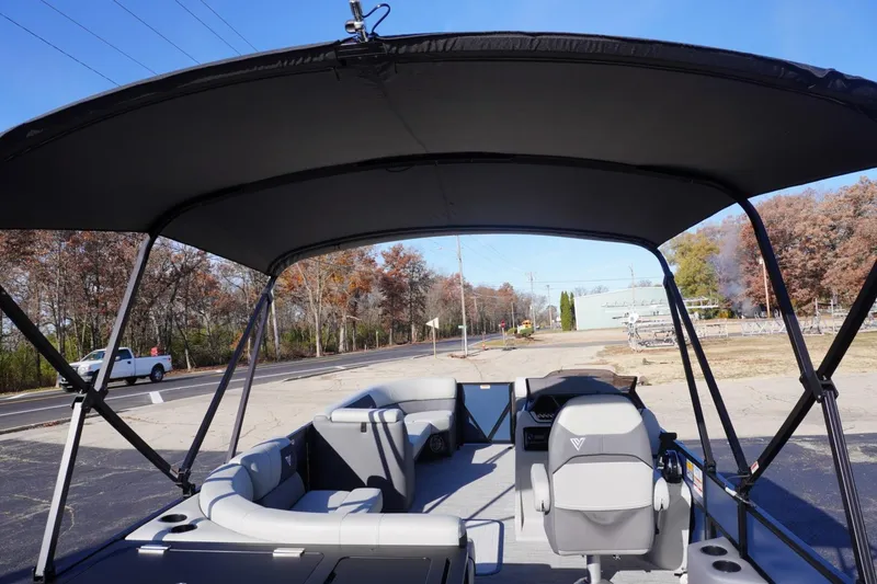 Slide: The Image of 2026 Viaggio Lago V-R boat interior with canopy, parked near road. - 67