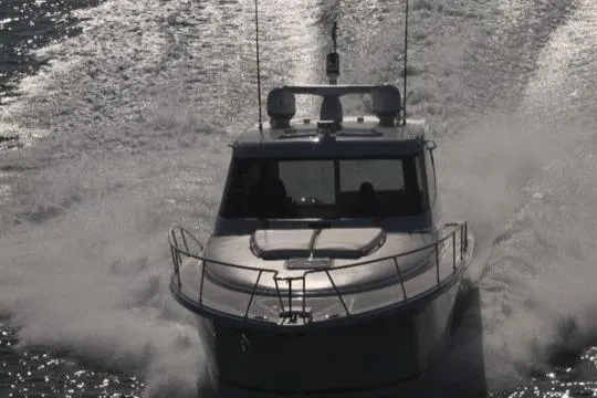 Slide: The Image of 2015 Jupiter 41 SB boat cruising on water, creating a dynamic splash. - 1