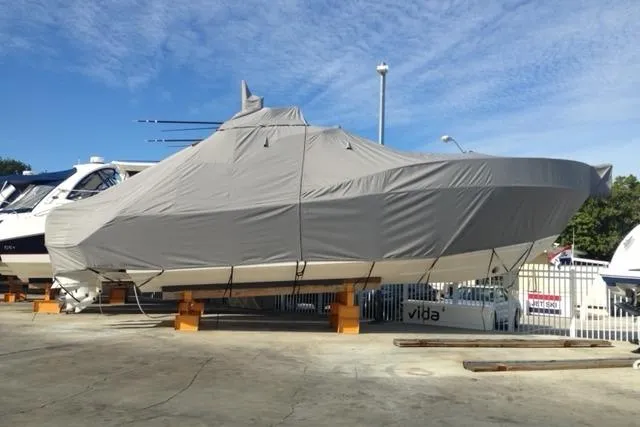 Slide: The Image of Covered 2015 Jupiter 41 SB boat on stands in a marina setting. - 11