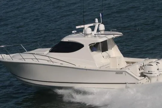 Slide: The Image of 2015 Jupiter 41 SB boat cruising on open water, side view. - 13