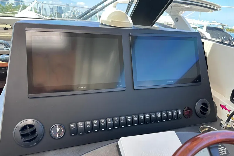Slide: The Image of Control panel of a 2015 Jupiter 41 SB boat with dual Garmin displays. - 18
