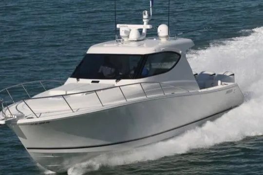 Slide: The Image of 2015 Jupiter 41 SB boat cruising on open water, showcasing sleek design and performance. - 2
