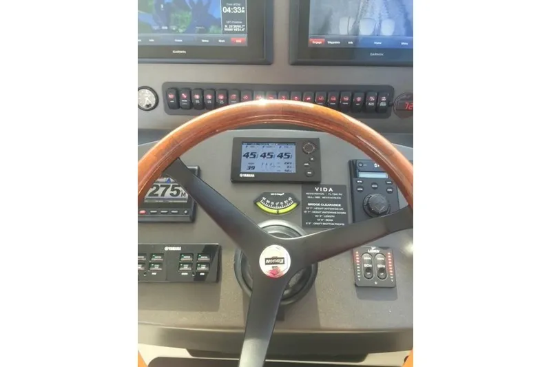 Slide: The Image of Helm of 2015 Jupiter 41 SB boat with navigation instruments and wooden steering wheel. - 21