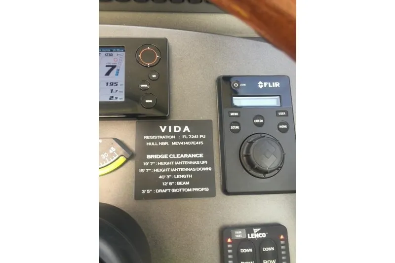 Slide: The Image of Control panel of a 2015 Jupiter 41 SB boat with registration details and specifications. - 23