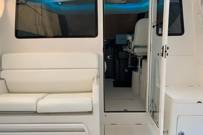 Slide: The Image of Interior view of 2015 Jupiter 41 SB boat with white seating and helm station. - 24