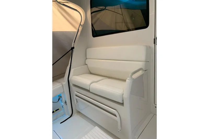 Slide: The Image of White cushioned seating on 2015 Jupiter 41 SB boat, featuring sleek design and modern interior. - 26