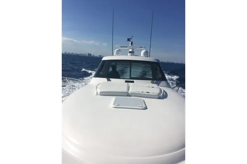 Slide: The Image of 2015 Jupiter 41 SB yacht cruising on open water with city skyline in background. - 3