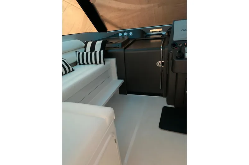 Slide: The Image of Interior of 2015 Jupiter 41 SB boat with striped cushions and modern helm. - 30