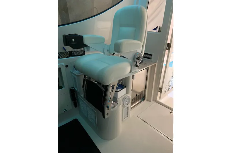 Slide: The Image of Captain's chair on 2015 Jupiter 41 SB boat, featuring white upholstery and modern design. - 31