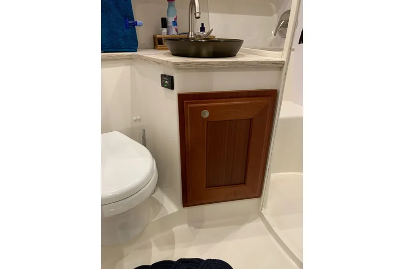 Slide: The Image of Bathroom interior of 2015 Jupiter 41 SB boat with wooden cabinet and modern fixtures. - 38