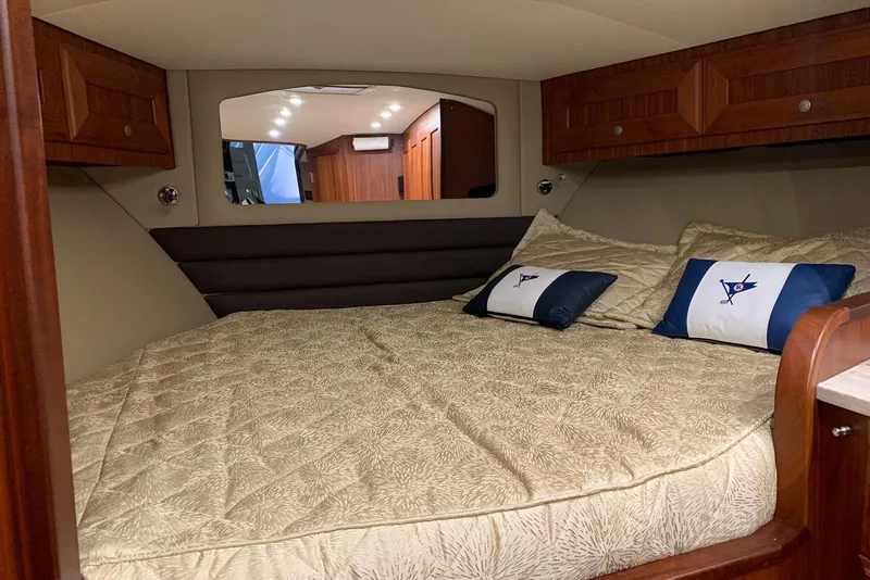 Slide: The Image of Luxurious cabin interior of 2015 Jupiter 41 SB yacht with cozy bedding and wooden accents. - 42