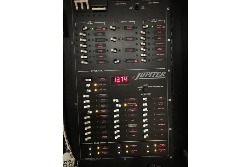 Slide: The Image of Control panel of a 2015 Jupiter 41 SB boat with switches and digital display. - 47