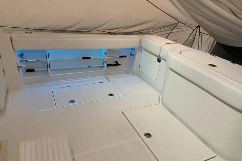 Slide: The Image of 2015 Jupiter 41 SB boat interior with white seating and storage compartments. - 50