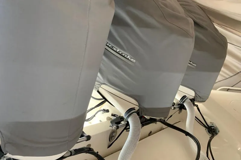 Slide: The Image of Three covered outboard motors on a 2015 Jupiter 41 SB boat. - 51