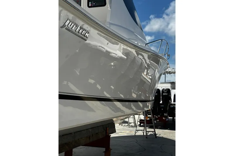 Slide: The Image of 2015 Jupiter 41 SB boat with sleek hull design under clear blue sky. - 53