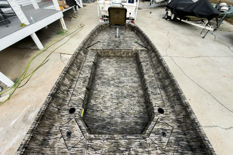 Slide: The Image of Open storage compartment on 2026 Excel 183 Tomahawk boat with camouflage design. - 10