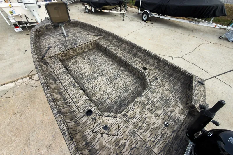 Slide: The Image of Open storage compartment on 2026 Excel 183 Tomahawk boat with camouflage design. - 11