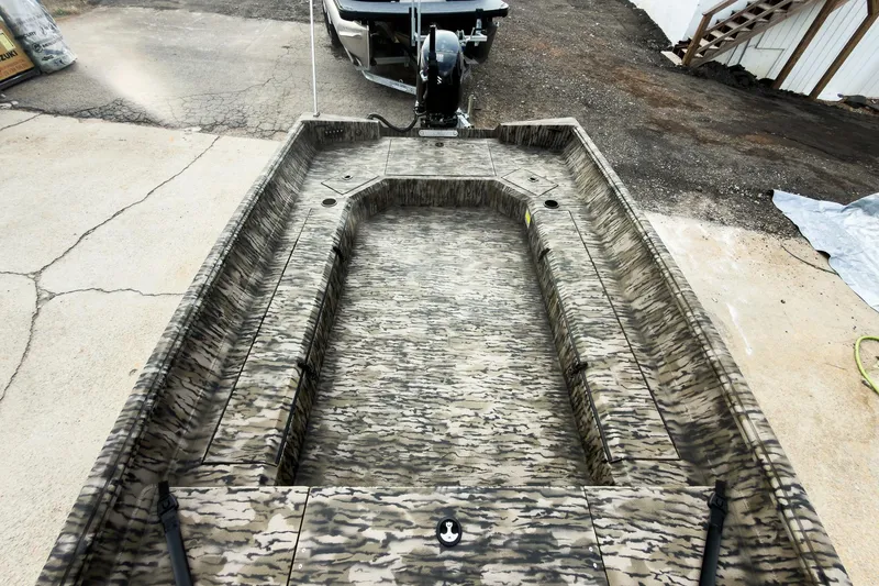 Slide: The Image of Open storage compartment in 2026 Excel 183 Tomahawk boat, featuring camouflage design. - 15