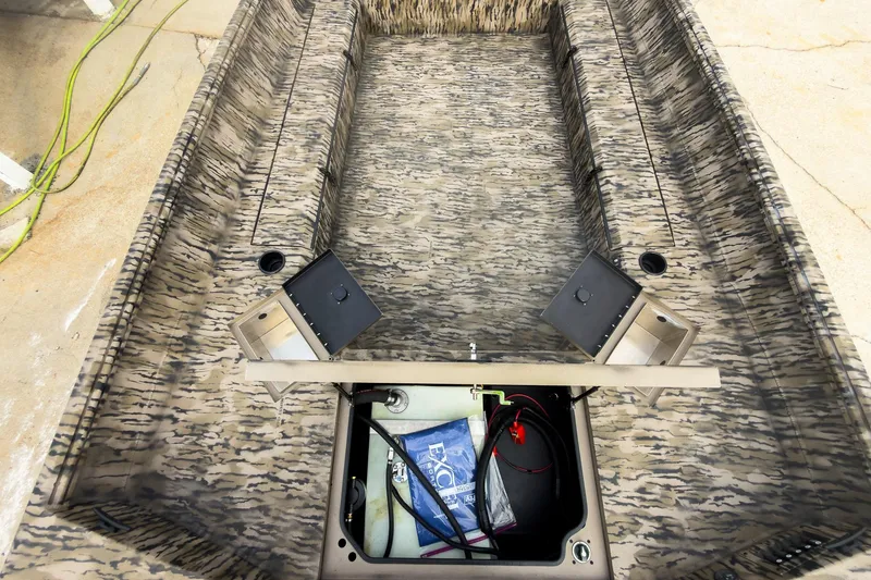 Slide: The Image of 2026 Excel 183 Tomahawk boat interior with camouflage design and open storage compartment. - 18