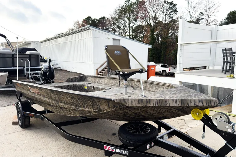 Slide: The Image of 2026 Excel 183 Tomahawk boat with camouflage design at indoor exhibition. - 3
