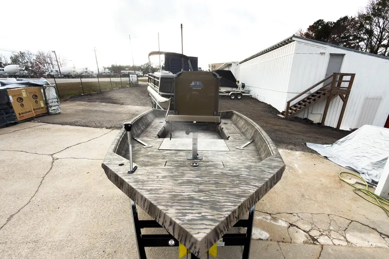 Slide: The Image of 2026 Excel 183 Tomahawk boat with camouflage design on display at a boat show. - 4