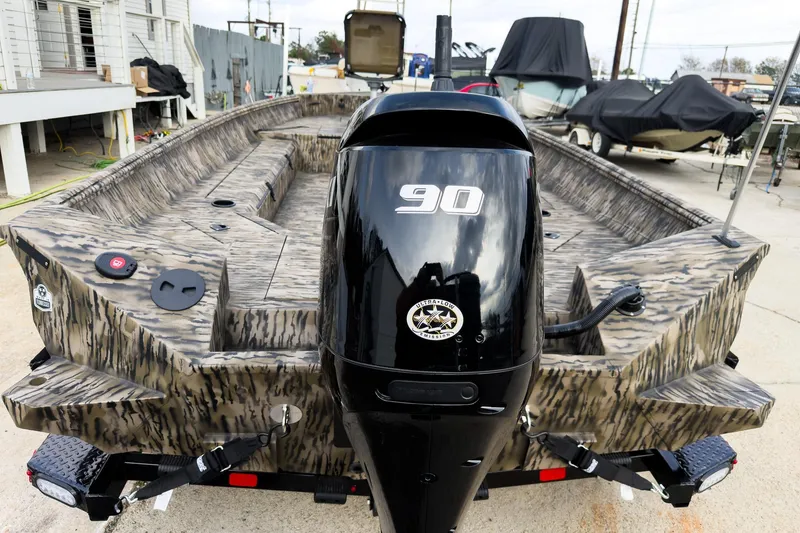 Slide: The Image of 2026 Excel 183 Tomahawk boat with camouflage design and powerful outboard motor. - 6