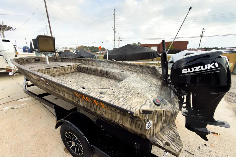 Slide: The Image of Camouflage-patterned 2026 Excel 183 Tomahawk boat interior at a showroom display. - 8