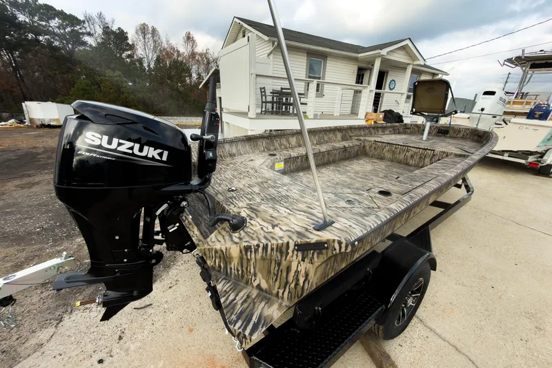 Slide: The Image of Camouflage-patterned deck of 2026 Excel 183 Tomahawk boat, featuring storage compartments. - 9