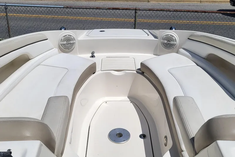 Slide: The Image of 2013 Sea Ray 260 Sundeck interior with white seating and speakers. - 10