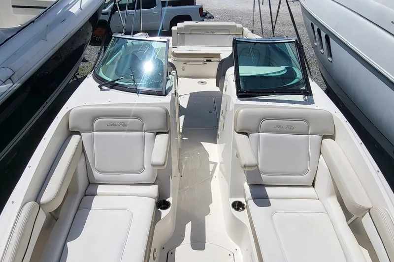 Slide: The Image of 2013 Sea Ray 260 Sundeck boat interior with white seating and windshield. - 12