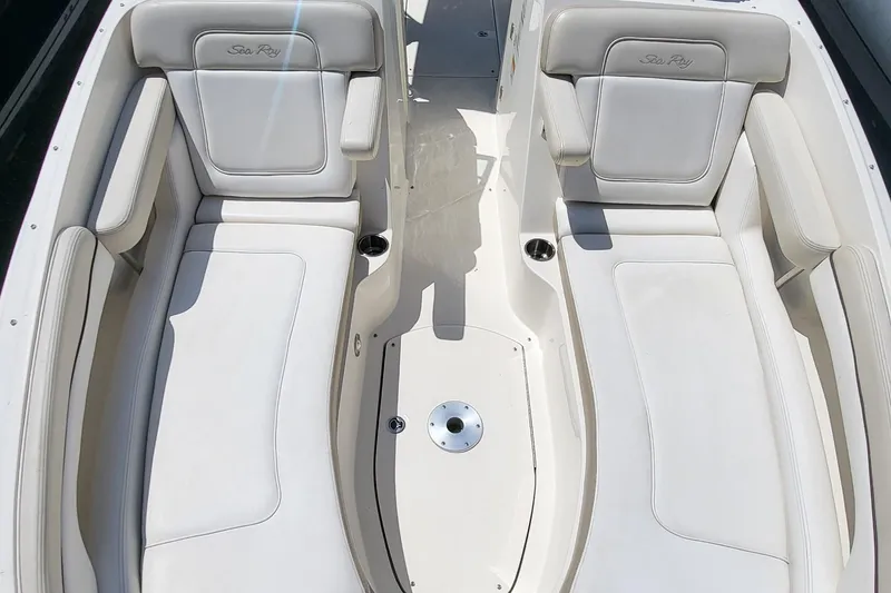 Slide: The Image of 2013 Sea Ray 260 Sundeck interior with white cushioned seating. - 13