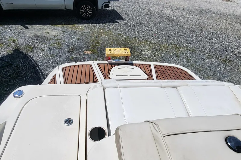Slide: The Image of 2013 Sea Ray 260 Sundeck boat with teak deck and white seating. - 15