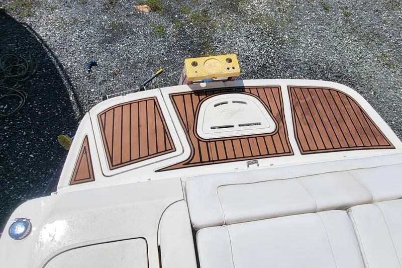 Slide: The Image of 2013 Sea Ray 260 Sundeck boat with teak deck and cushioned seating. - 16