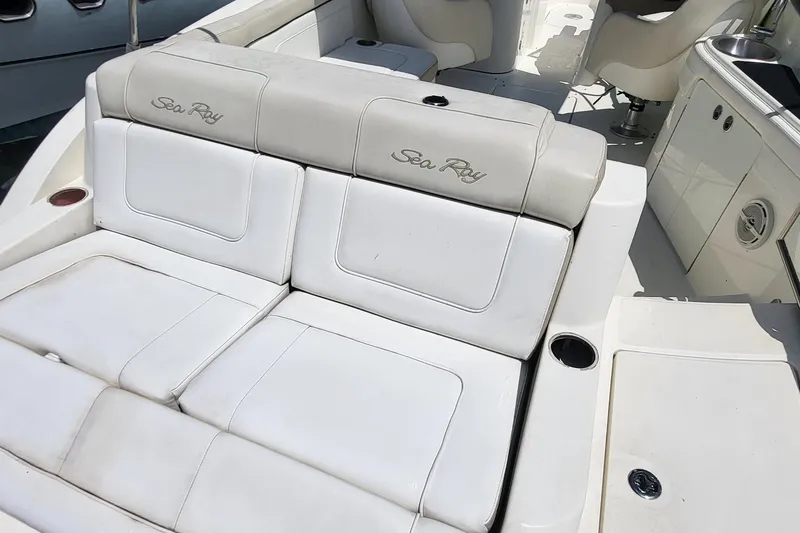 Slide: The Image of 2013 Sea Ray 260 Sundeck interior with white seating and cup holders. - 17